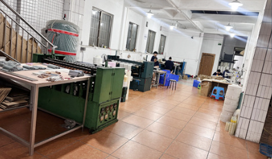 Production floor with workers assembling lampshades